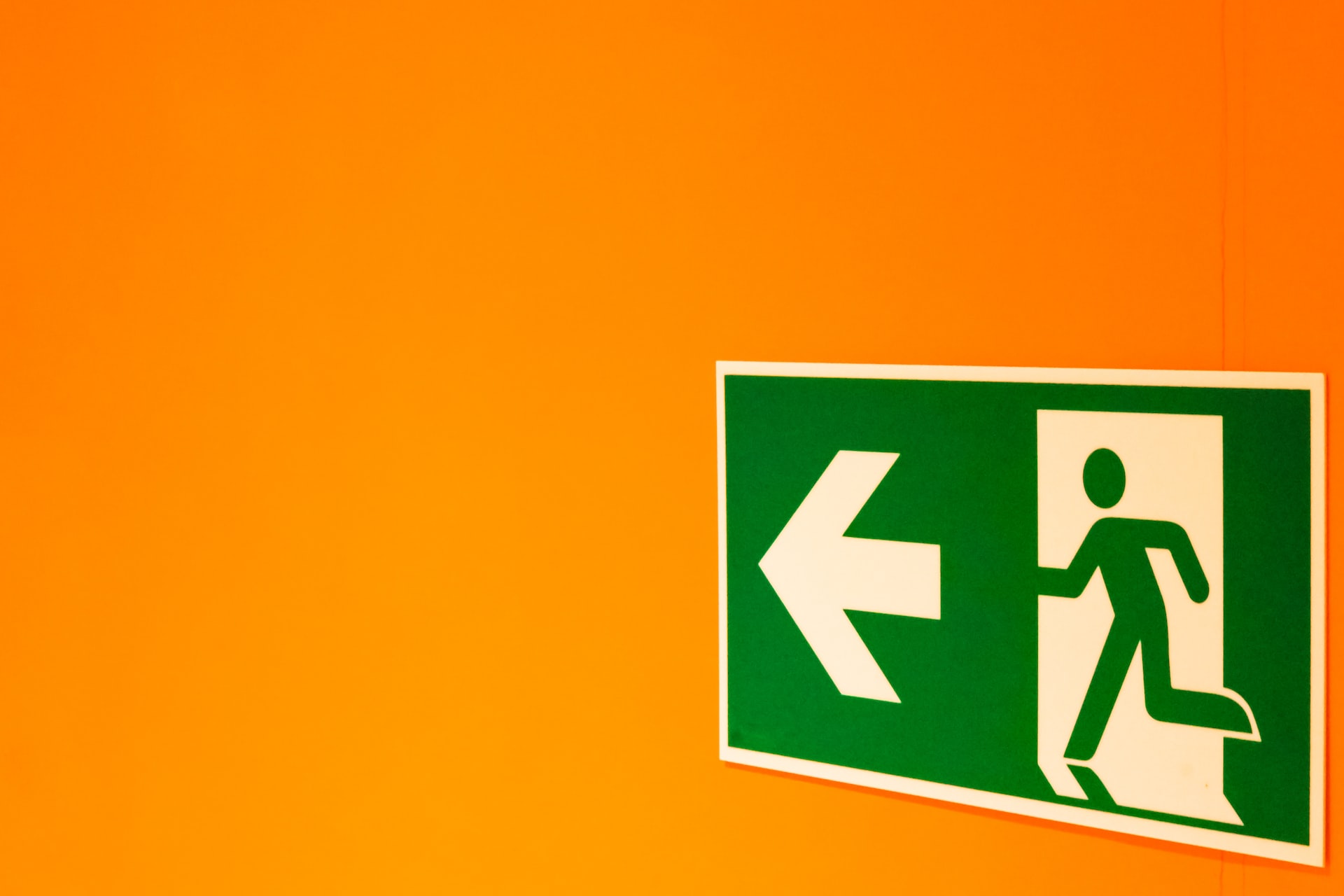green exit sign on orange background