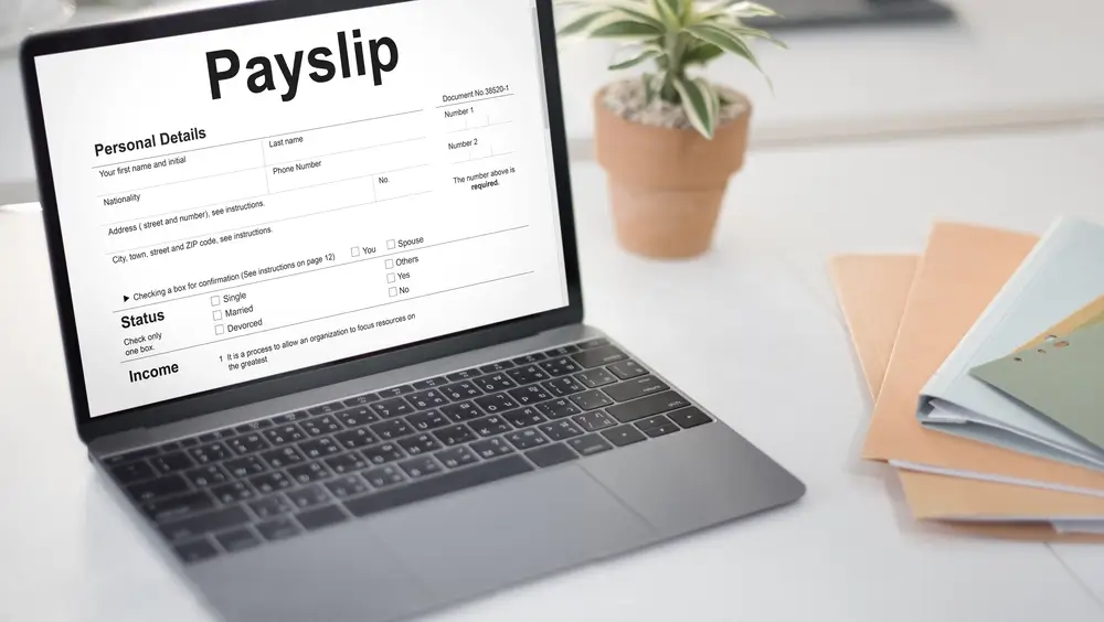 man handling payroll process on laptop
