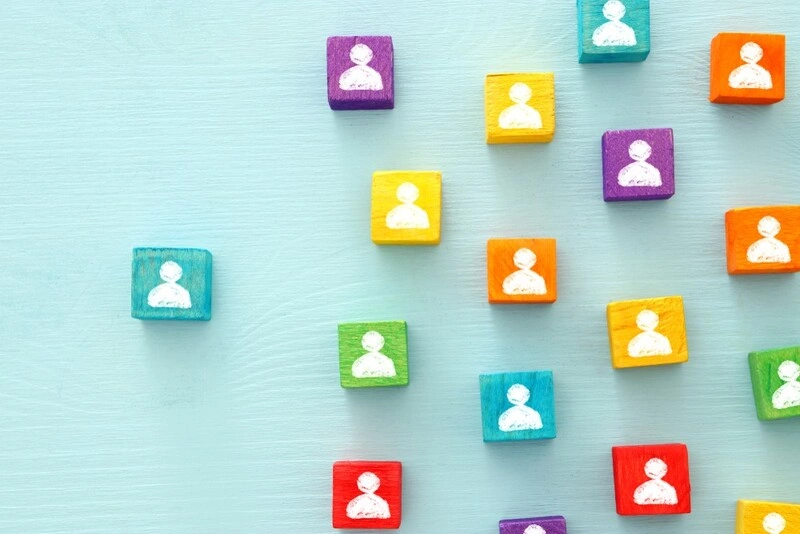 wooden colourful dices with people avatars printed on their faces